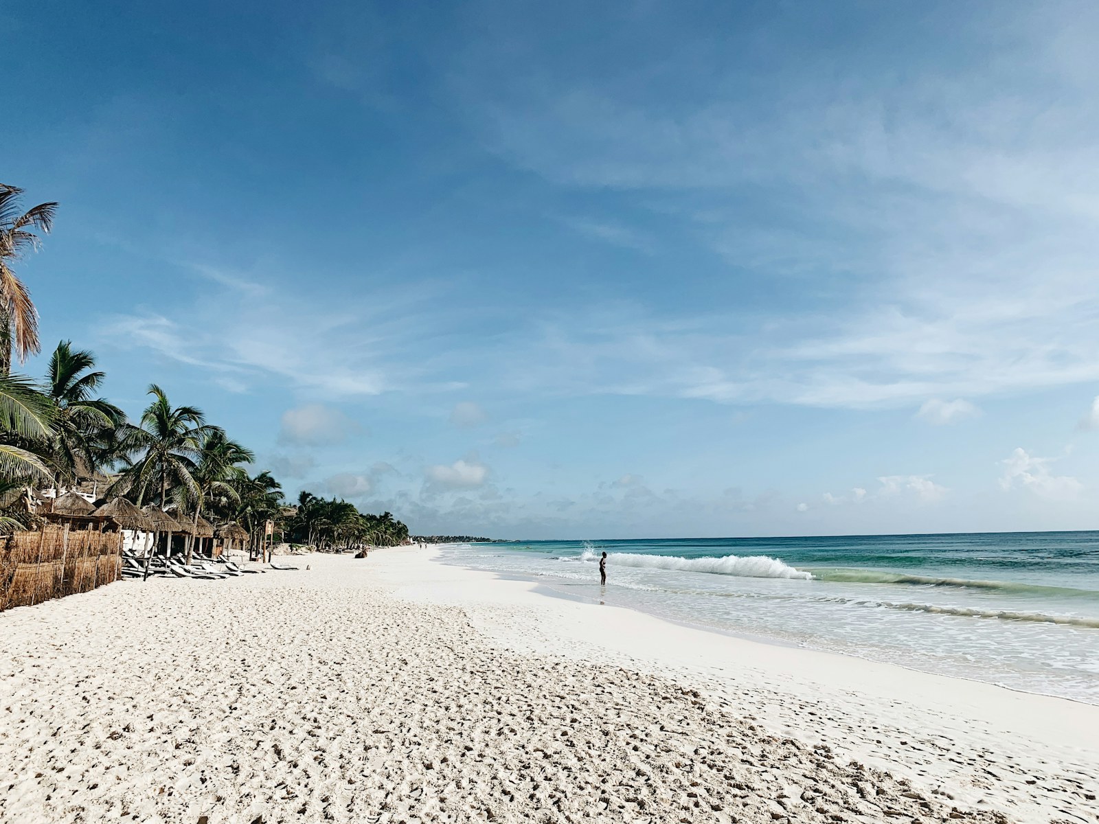 Tulum beach with palapas, an easy day trip from Playa del Carmen by bus or colectivo